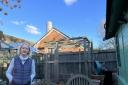 Stephanie Sfakianos, 66, shown in her back garden in front of the fuel tank and chimney of the academy (Credit: Joe Coughlan)