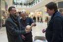 Assistant curator Dan Nesbitt and archaeology ambassador Jim Farbon talk to shoppers about Roman life