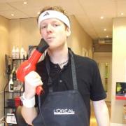 Taking it seriously: Dan with the hairdryer - before he dropped it on the customer