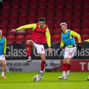 Charlton Athletic's Ryan Inniss (centre left) and team-mate Charlie Kirk warm up on the pitch ahead of the Papa John's Trophy round of sixteen match at The Valley, London