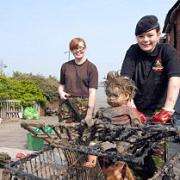 Natasha Booth and Jade Rhodes both aged 14 with one of the 50-plus shopping trolleys retrieved from the mudflats
