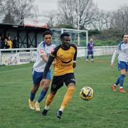 Cray Wanderers captain Anthony Cook shields the ball from Enfield Town's Johnville Renee during the 1-1 draw on Saturday.