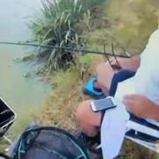 An Environment Agency fisheries officer books a man later prosecuted for fishing without a licence at a lake in Kent