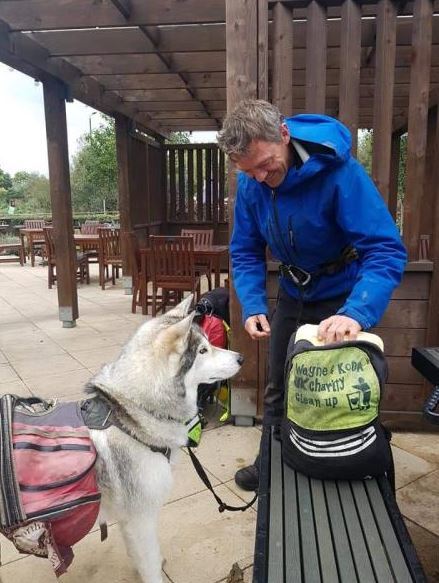 One man and his dog - Good samaritan walking along the Thames and picking up litter for charity