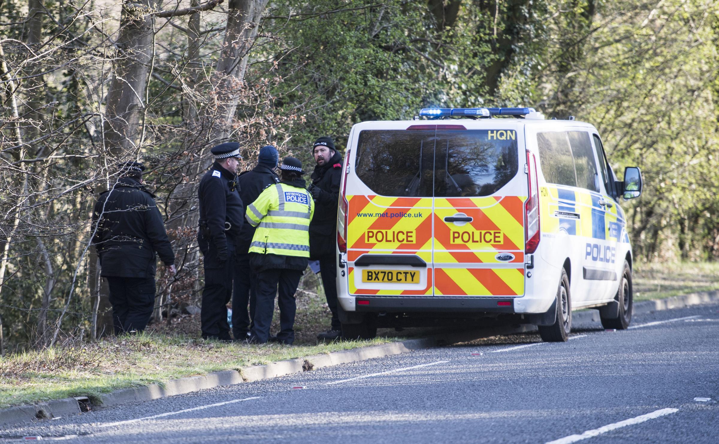 Metropolitan Police officers at the scene at the Wake Valley pond in Epping Forest following the discovery of a mans body. Ian West/PA Wire 