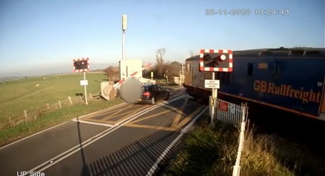 Video footage showed the moment careless driver Andrew Bryant narrowly escaped being crushed by a train in his Volkswagen at a level crossing in Sussex