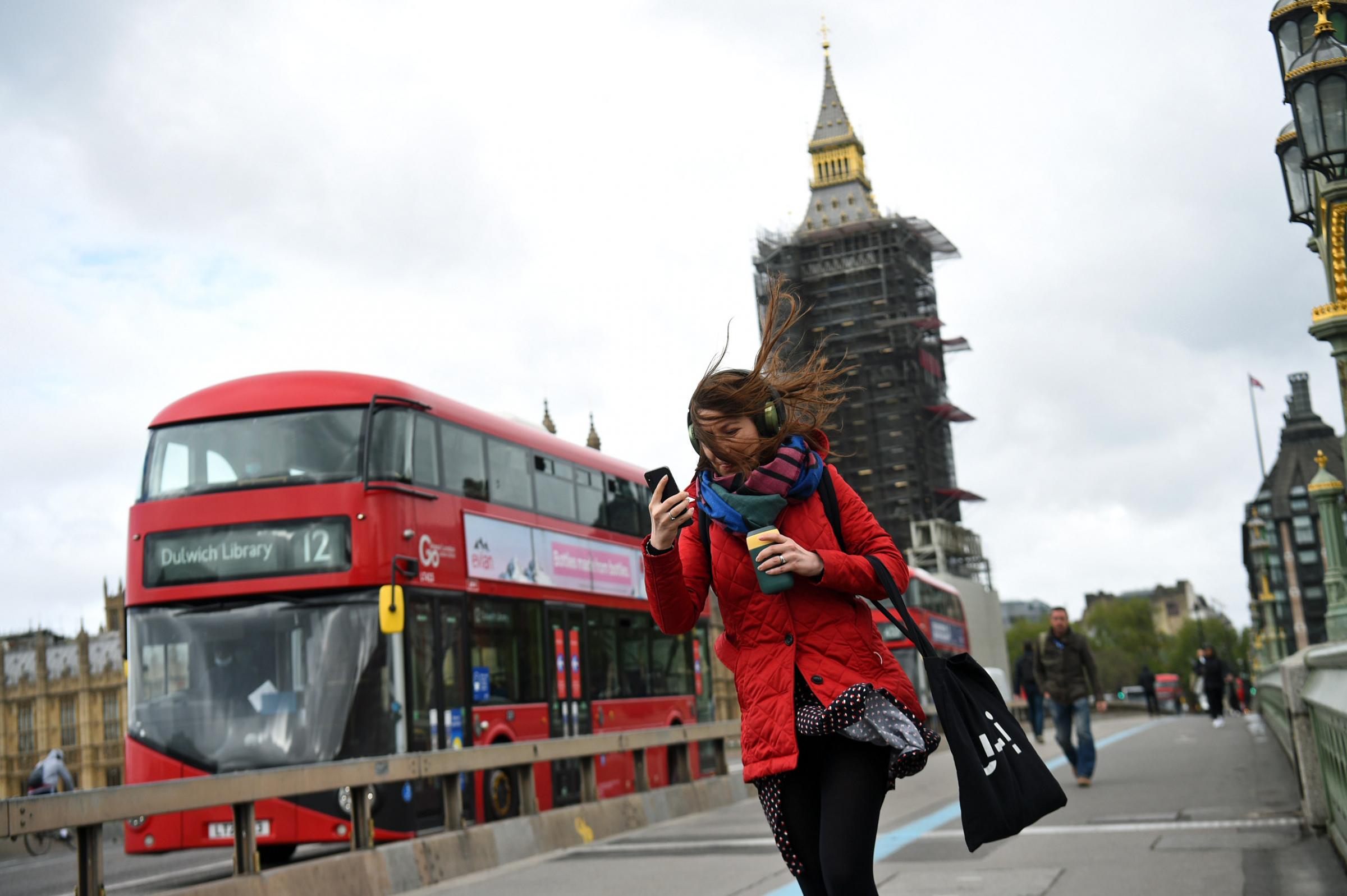 A woman buffeted by the wind whilst crossing the Westminster Bridge, London. Kirsty OConnor/PA Wire 