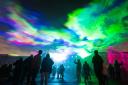 People view 'Borealis' a laser light art installation by Dan Acher which recreates the northern lights, as part of the Greenwich and Docklands Intentional Festival at Royal Artillery Barracks in Woolwich (photo: PA)