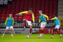 Charlton Athletic's Ryan Inniss (centre left) and team-mate Charlie Kirk warm up on the pitch ahead of the Papa John's Trophy round of sixteen match at The Valley, London