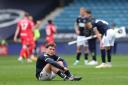 Millwall’s Callum Styles sits dejected after the loss to Blackburn