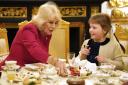 Queen Camilla takes tea with seven-year-old Olivia Taylor from Sidcup at Windsor Castle, Berkshire. The blind schoolgirl with a brain tumour sang a Christmas song and gave the Queen a handmade ring when she was invited to Windsor Castle