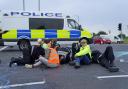 Police officers work to free protesters who had glued themselves to the highway at a slip road at Junction 4 of the A1(M), near Hatfield, where climate activists carried out a further action after demonstrations which took place last week (photo: PA)