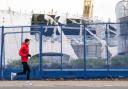People take photos of the O2 Arena in London, after parts of its roof were ripped off in high winds as Storm Eunice struck (images .pamedia)