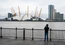 A man takes a photo of the O2 Arena in London, after parts of its roof were ripped off in high winds as Storm Eunice struck (images pa media)