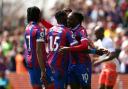 Eberechi Eze (right) celebrates with Michael Olise (left) and Jeffrey Schlupp (centre) after scoring a penalty for Crystal Palace in the 4-3 win over West Ham