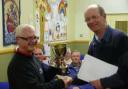 Spring Park chairman Graham Evans hands over a cup won at a film festival in Guildford