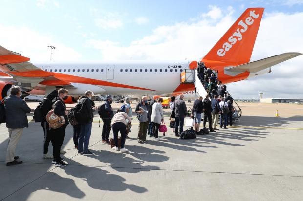 News Shopper: People queue to board an EasyJet plane. (PA)