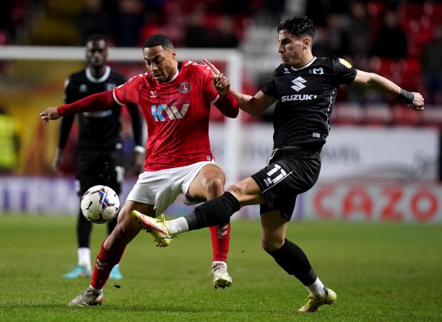 News Shopper: Charlton Athletic's Akin Famewo (left) and MK Dons' Theo Corbeanu battle for the ball during the Sky Bet League One match at The Valley, London.