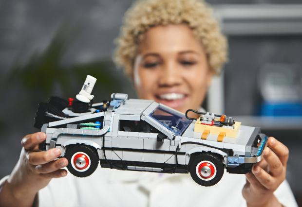 News Shopper: A woman holding the LEGO Back to The Future Delorean set. Credit: LEGO
