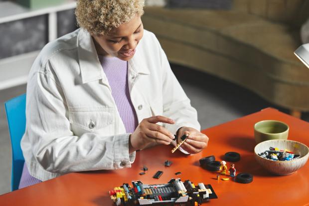 News Shopper: A woman putting together the LEGO Delorean. Credit: LEGO