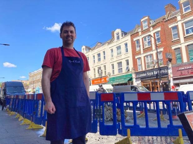 News Shopper: Julian Beaumont owner of Good Food grocery store said he was worried about the amount of water being wasted (photo: Robert Firth)