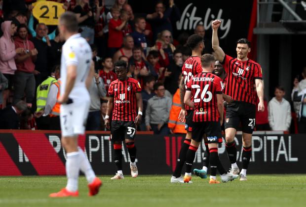 News Shopper: Bournemouth's Kieffer Moore (right) celebrates scoring their side's first goal of the game with team-mates as Millwall's Jed Wallace (left) looks dejected during the Sky Bet Championship match at the Vitality Stadium, Bournemouth