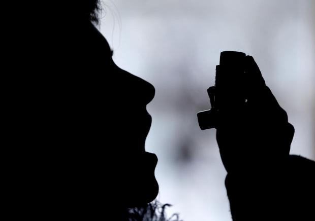 News Shopper: Silhouette of a person using an inhaler. Credit: Canva