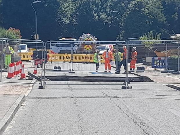 News Shopper: Police tape and mental fencing blocked the public off from the 5m wide sinkhole that opened up on Martens Avenue (photo: Kiro Evans)