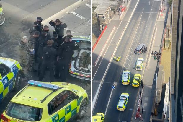 Emergency personnel attending to a man on Creek Road, Greenwich where a man was shot by police following an incident after officers responded to multiple 999 reports of a man with a firearm (photos: PA)