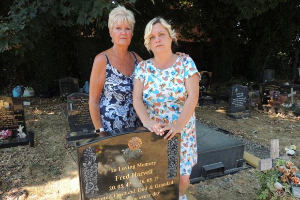Barbara Harvell (left) with her daughter Clare Scovell at Fred Harvell's grave in Eastleigh Cemetery
