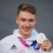 Cyclist Ethan Hayter holds his Olympic silver medal at a homecoming party at Herne Hill Velodrome in south London - PA