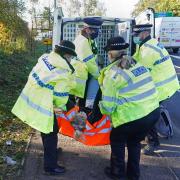 A protester from Insulate Britain is removed by police after they glued their hands to the road near to the South Mimms roundabout at the junction of the M25 and A1 (photo: PA)