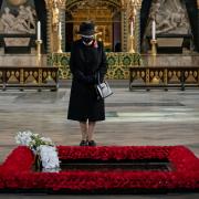 REMEMBRANCE: Queen Elizabeth II inspects a bouquet of flowers placed on her behalf at the grave of the Unknown Warrior during a ceremony in Westminster Abbey last year. Picture Credit: PA