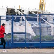People take photos of the O2 Arena in London, after parts of its roof were ripped off in high winds as Storm Eunice struck (images .pamedia)