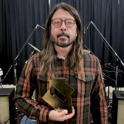 Dave Grohl of the Foo Fighters with their Official Number 1 Album Award from the Official Charts Company for Medicine at Midnight. Picture: PA/Official Charts Company