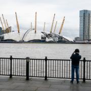 A man takes a photo of the O2 Arena in London, after parts of its roof were ripped off in high winds as Storm Eunice struck (images pa media)