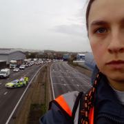 A protester who has climbed a gantry on the M25 between junctions six and seven in Surrey, leading to the closure of the motorway
