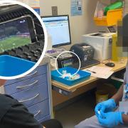 A triage technician at Queen Elizabeth Hospital, Woolwich, apologised after being photographed watching football on his phone while treating a patient