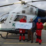 Lion John Scott presents a cheque to Kent Air Ambulance