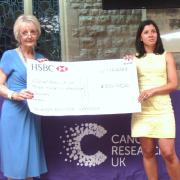 Barbara Ash, on the left, presents the cheque.