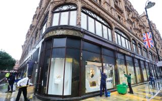 Harrods in Knightsbridge is cleaned after activists from Just Stop Oil sprayed an orange substance on its windows
