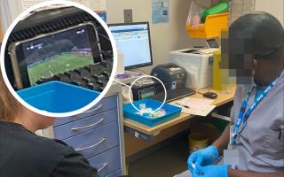 A triage technician at Queen Elizabeth Hospital, Woolwich, apologised after being photographed watching football on his phone while treating a patient